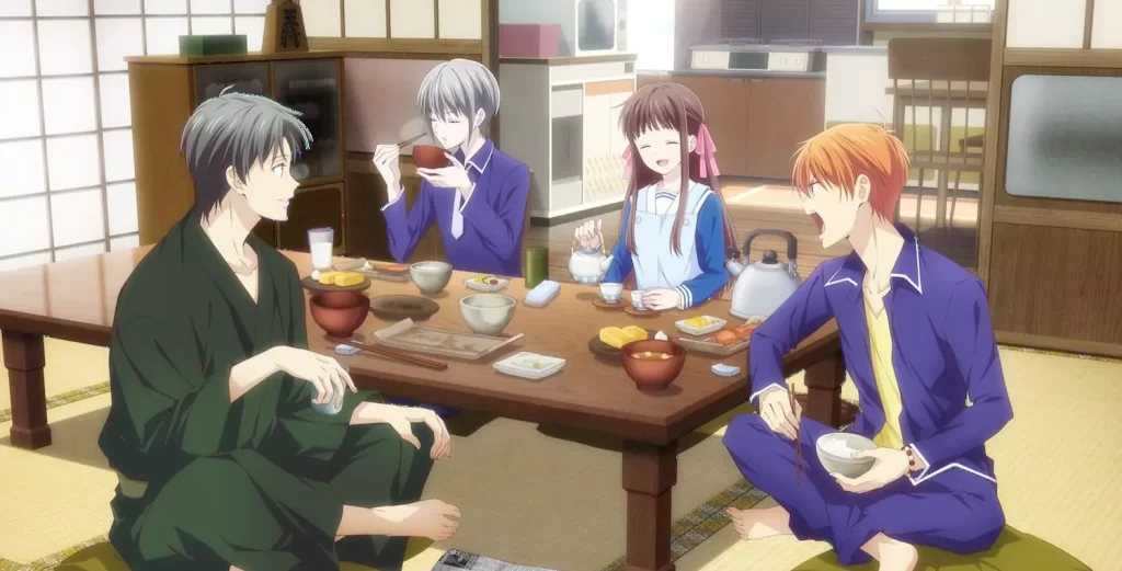 Tohru Honda shares a warm breakfast with Yuki, Kyo, and Shigure Sohma in a traditional Japanese living room, from the anime Fruits Basket.