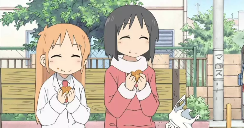 From Nichijou anime, Mio and Yuuko enjoy snacks together on a bench, smiling happily with a bag and food in hand.