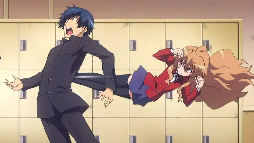 Taiga delivers a flying kick to Ryuuji in front of the school lockers in a comedic scene from the beloved romance anime Toradora!