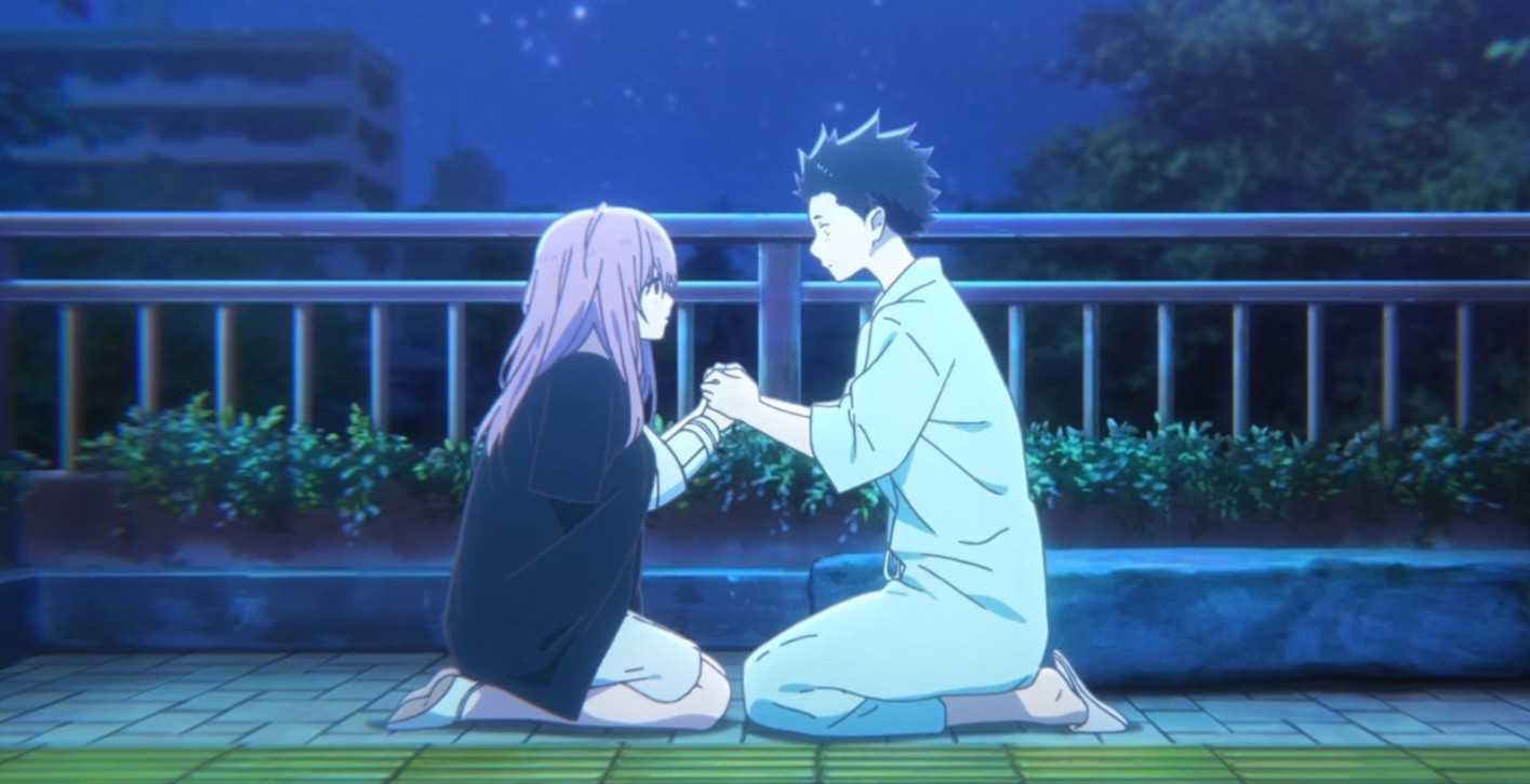 A heartfelt scene from the anime movie A Silent Voice, with Shoya and Shoko kneeling under the night sky, holding hands.