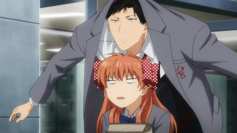 Tall Umetarou Nozaki with an intense, deadpan look over an unamused Chiyo Sakura.