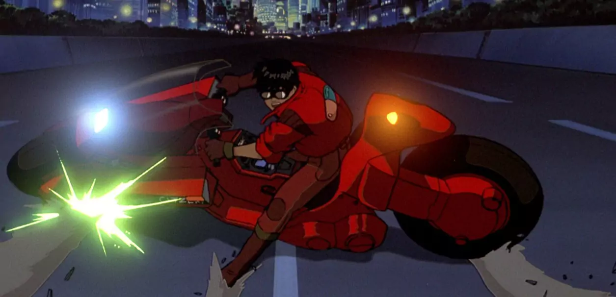 Kaneda drifts on his iconic red bike through Neo-Tokyo in Akira, a genre-defining sci-fi classic in anime history.