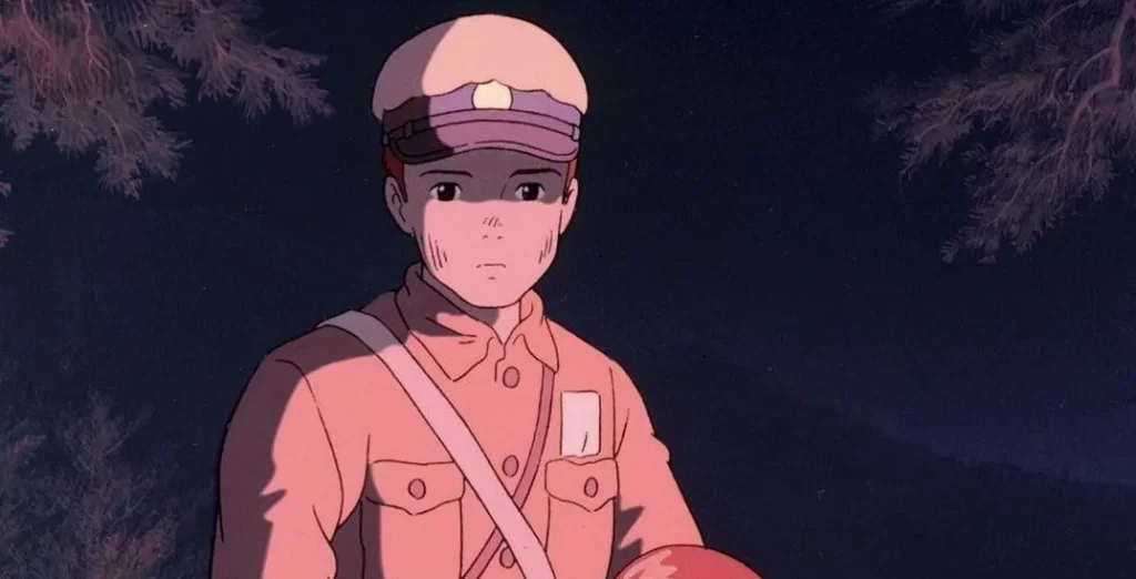 Seita stands solemnly under the night sky in Grave of the Fireflies film, reflecting the film’s tragic tone.
